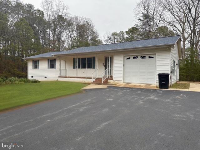 ranch-style house with a garage and a front lawn