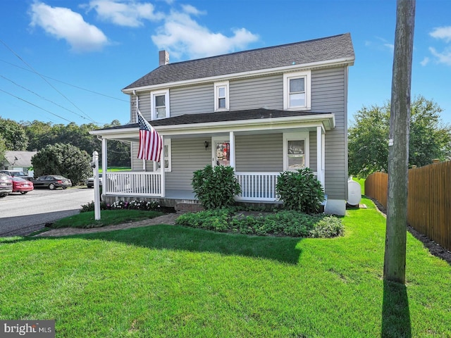 view of front of house with a porch and a front lawn