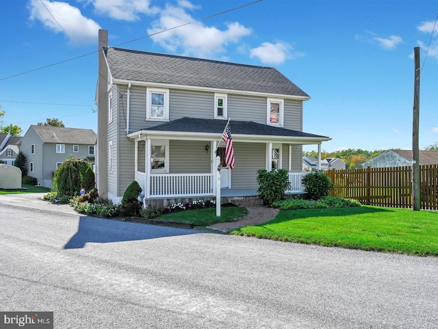 view of front facade featuring a front yard and a porch