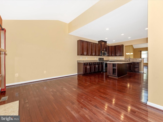 unfurnished living room with dark wood-type flooring, lofted ceiling, and sink