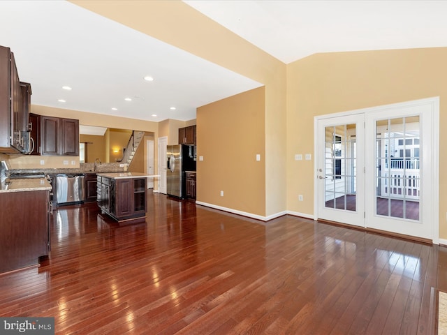 unfurnished living room featuring sink, vaulted ceiling, and dark hardwood / wood-style floors