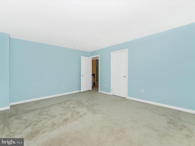 unfurnished room featuring light carpet