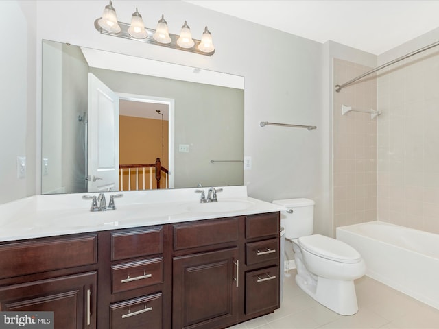 full bathroom featuring vanity, tiled shower / bath, tile patterned floors, and toilet