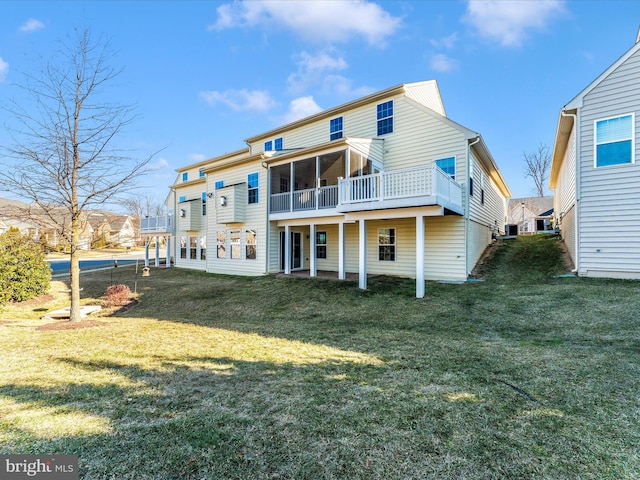 rear view of property featuring a yard