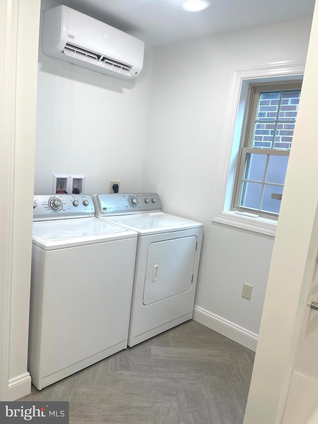 washroom featuring a wall mounted AC and washing machine and dryer