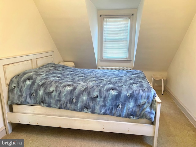 carpeted bedroom featuring lofted ceiling