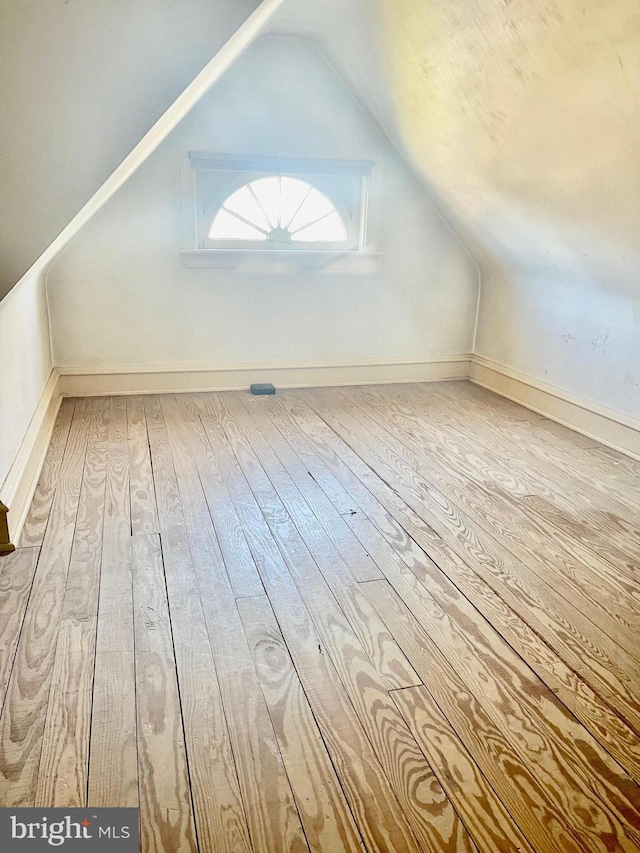 bonus room featuring lofted ceiling and light hardwood / wood-style flooring