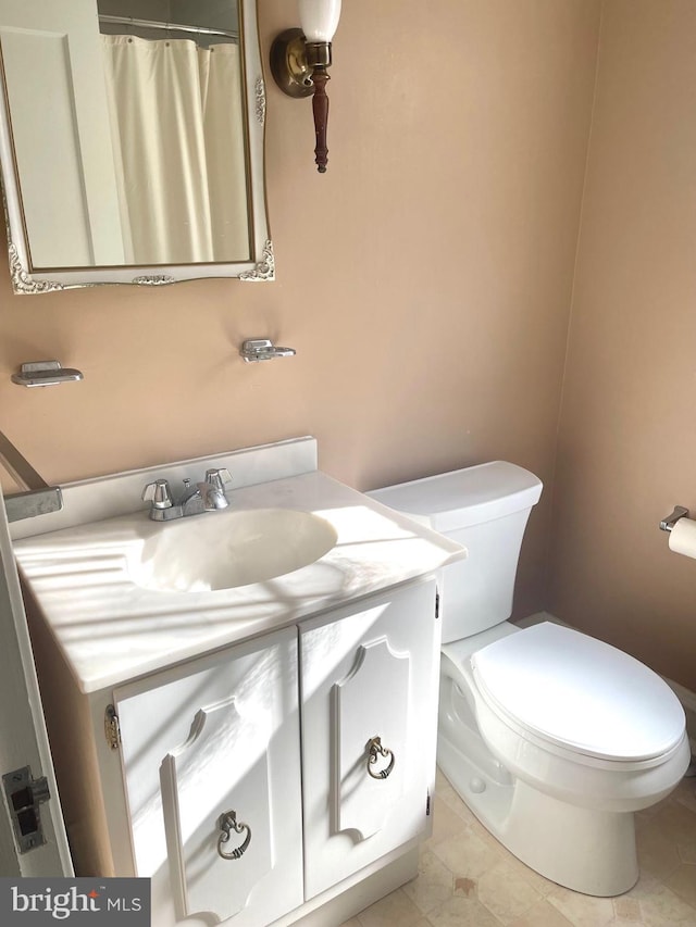 bathroom with vanity, toilet, and tile patterned flooring