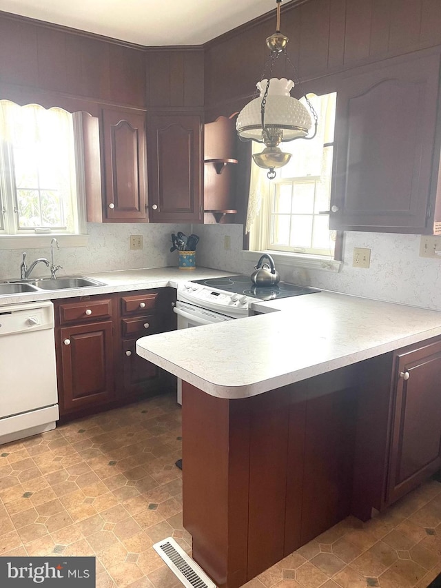 kitchen with white appliances, sink, and backsplash