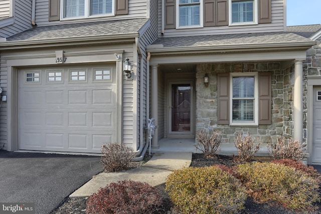 doorway to property with a garage