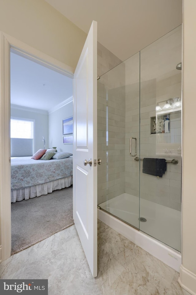 bathroom featuring crown molding and a shower with shower door