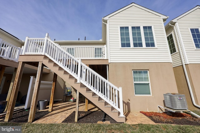 back of property featuring central AC unit