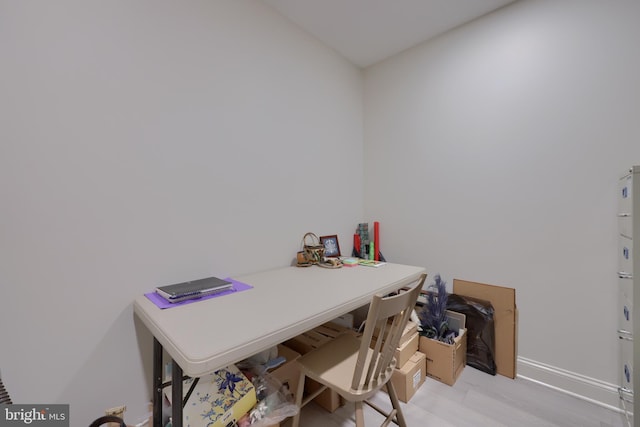 home office with light hardwood / wood-style flooring