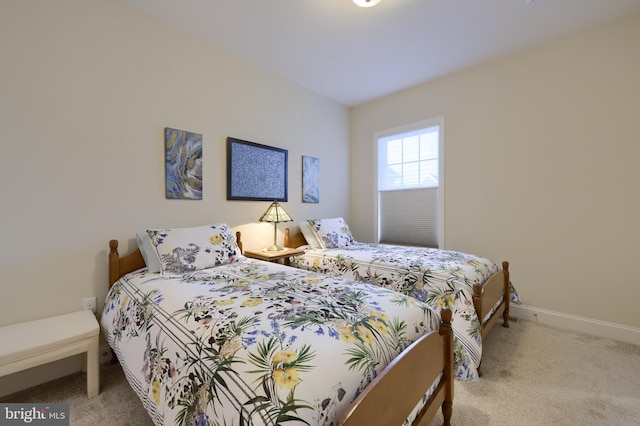 bedroom featuring light colored carpet