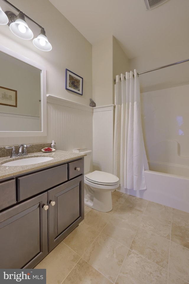 full bathroom featuring shower / tub combo with curtain, vanity, tile patterned floors, and toilet