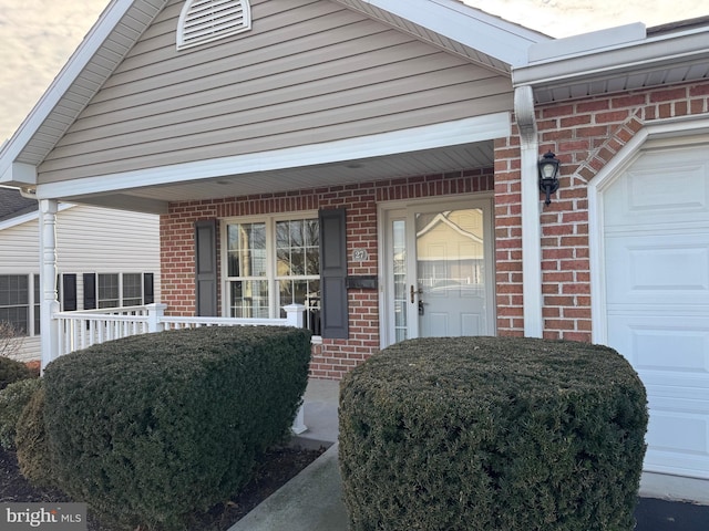 view of exterior entry with a porch