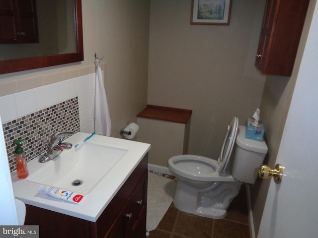 bathroom featuring vanity, tile patterned flooring, tasteful backsplash, and toilet