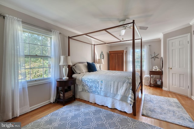 bedroom featuring hardwood / wood-style flooring, ceiling fan, and ornamental molding