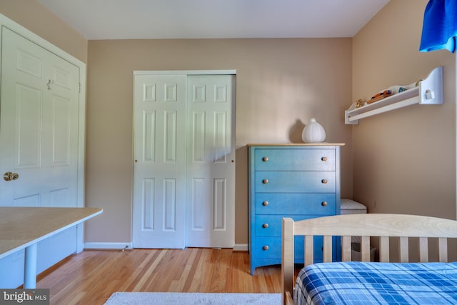 bedroom with a closet and light hardwood / wood-style flooring