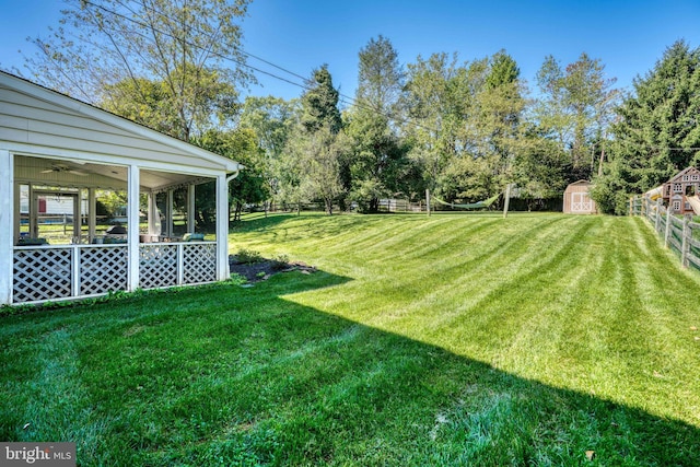 view of yard featuring a storage shed and a sunroom