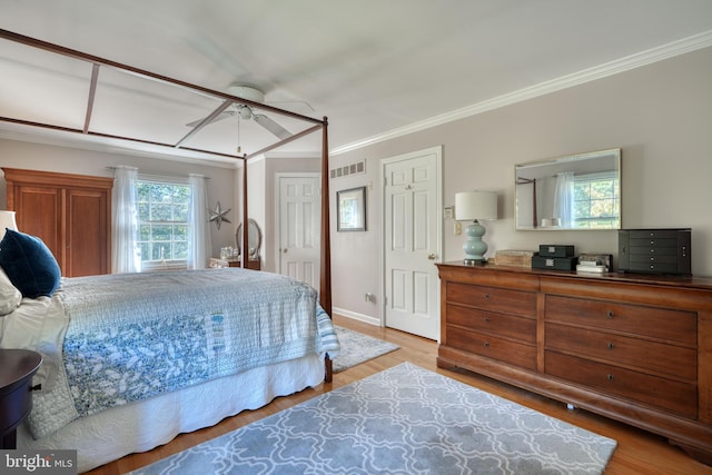 bedroom featuring crown molding and light wood-type flooring