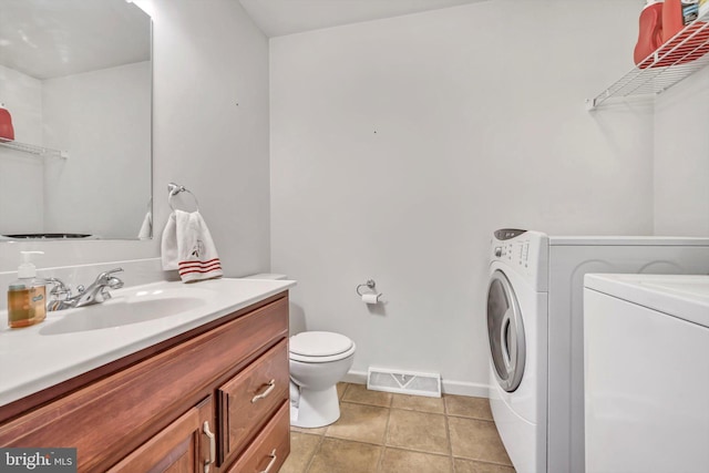 bathroom with vanity, tile patterned floors, independent washer and dryer, and toilet