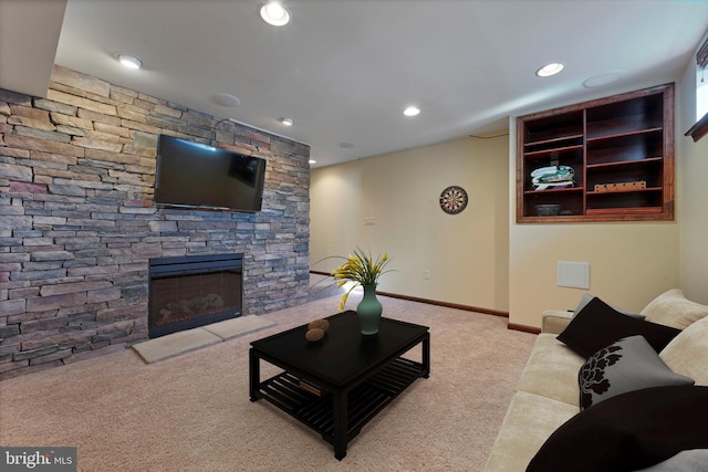 living room featuring a fireplace and light carpet