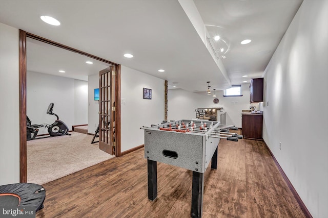 recreation room with light hardwood / wood-style floors