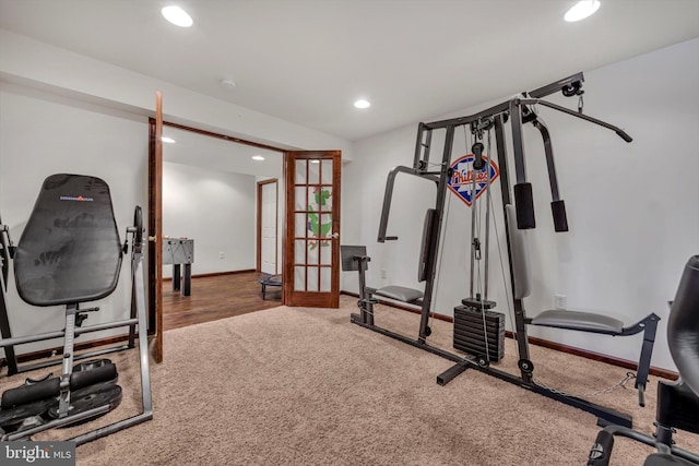 exercise area featuring carpet floors and french doors