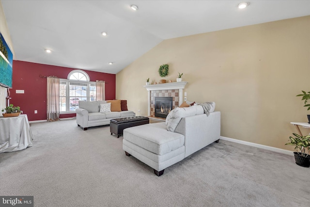 carpeted living room with lofted ceiling and a tiled fireplace