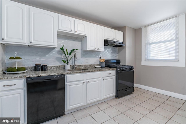 kitchen with tasteful backsplash, white cabinetry, sink, light stone counters, and black appliances