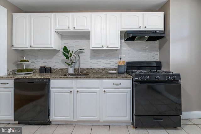 kitchen featuring sink, black appliances, ventilation hood, dark stone counters, and white cabinets