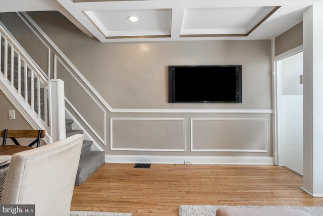 living room with coffered ceiling, hardwood / wood-style floors, and beam ceiling