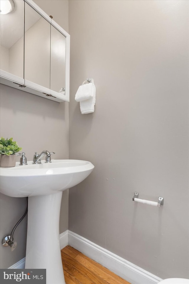 bathroom with sink and hardwood / wood-style floors