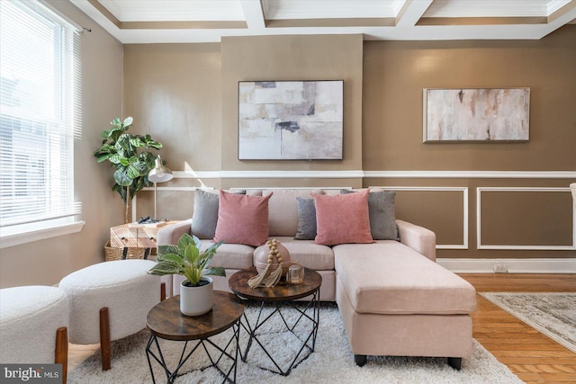 living room featuring hardwood / wood-style flooring, ornamental molding, coffered ceiling, and beam ceiling