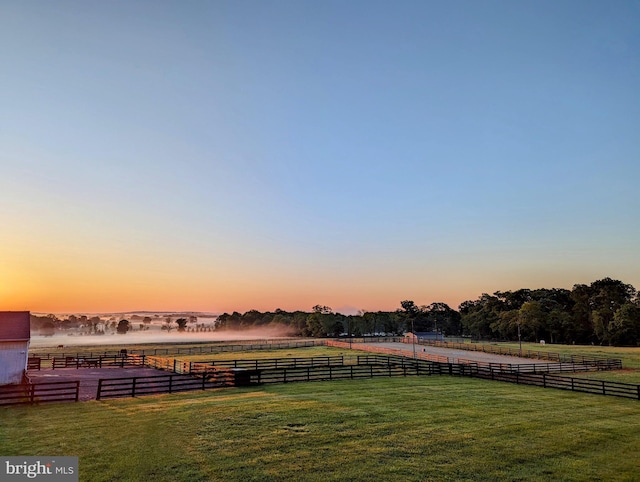 yard at dusk with a rural view