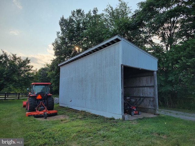 outdoor structure at dusk featuring a lawn