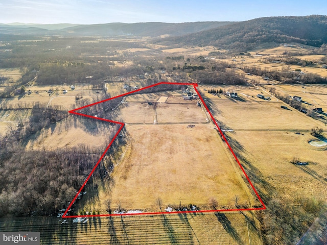 drone / aerial view with a mountain view and a rural view