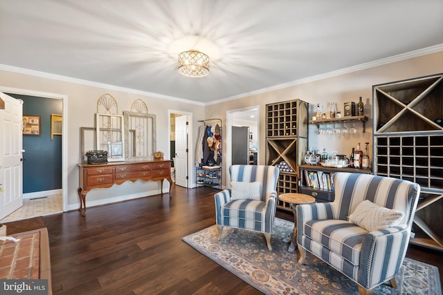 sitting room featuring crown molding and dark wood-type flooring