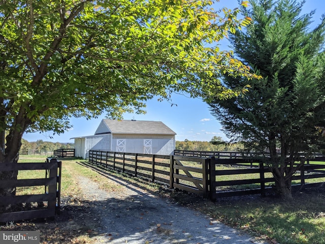 exterior space featuring an outdoor structure and a rural view