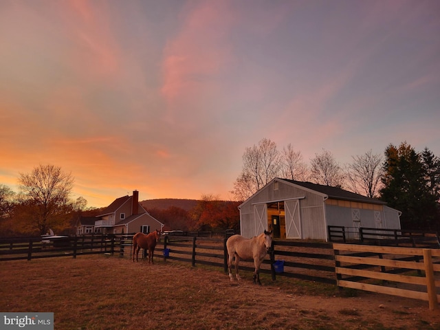 view of horse barn with a rural view