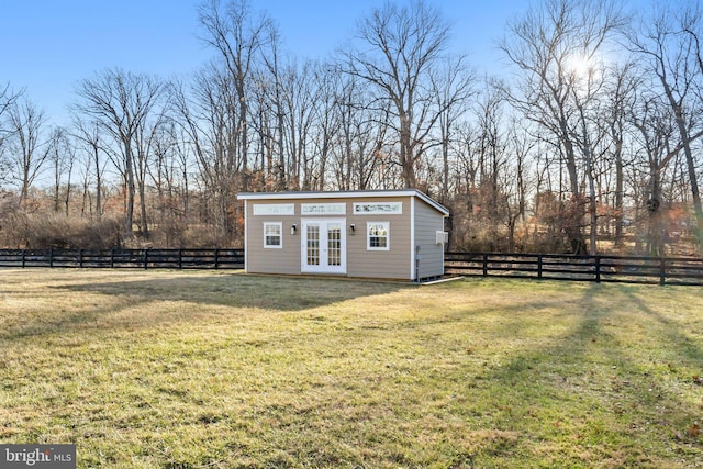 view of outbuilding with french doors and a lawn