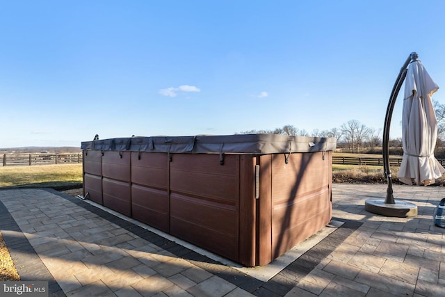 view of outdoor structure with a hot tub and a rural view