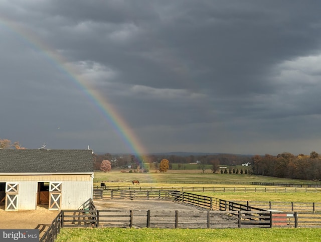 view of yard featuring a rural view and an outbuilding