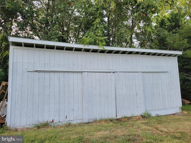 view of outdoor structure with a lawn