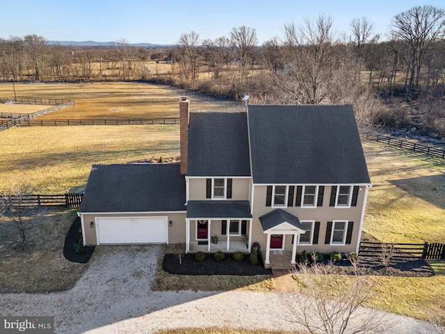 view of front of property featuring a rural view and a garage