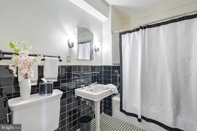 bathroom featuring tile walls, tile patterned floors, and shower / bathtub combination with curtain