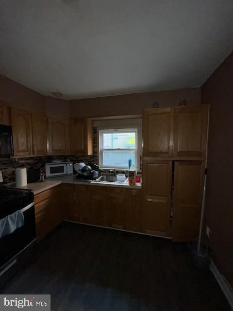 kitchen with backsplash, sink, and stove