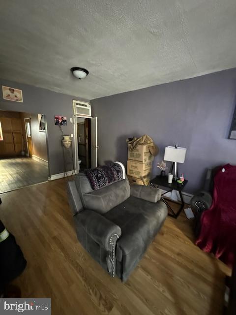 sitting room with wood-type flooring and a textured ceiling