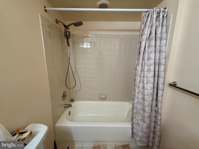 bathroom with shower / bath combo with shower curtain